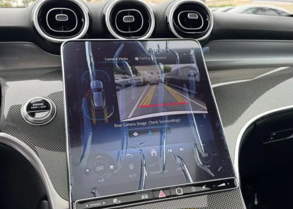 Car dashboard with a touchscreen display showing rear camera view.