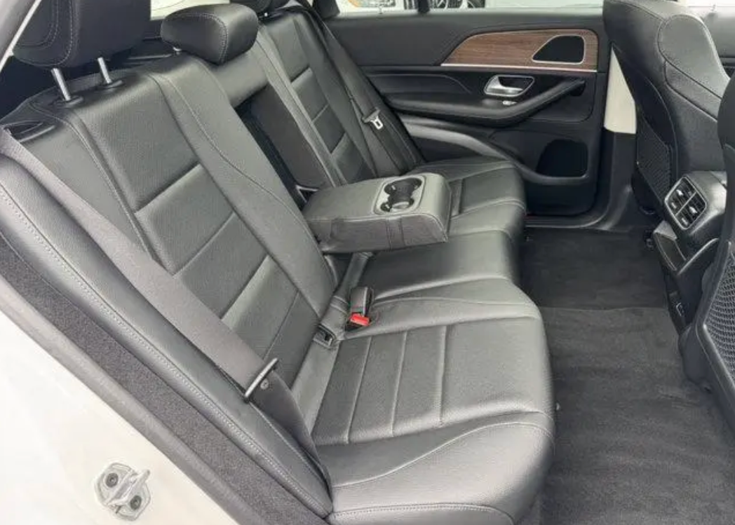 Car interior with gray seats and a focus on the back seat.
