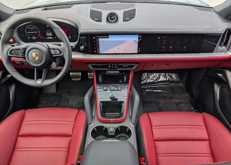 Car interior with red seats and a modern dashboard featuring a touchscreen display.