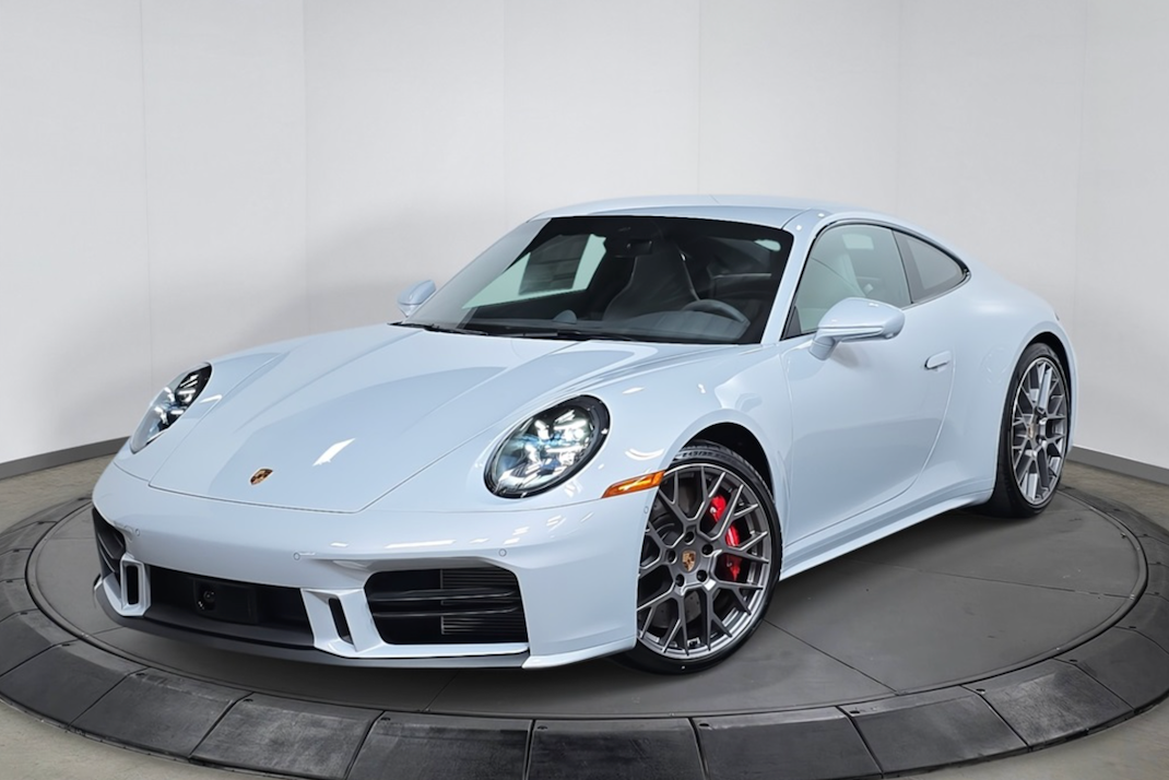 White Porsche sports car on a turntable against a white background