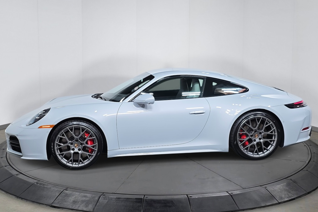 White sports car on a turntable with a plain background