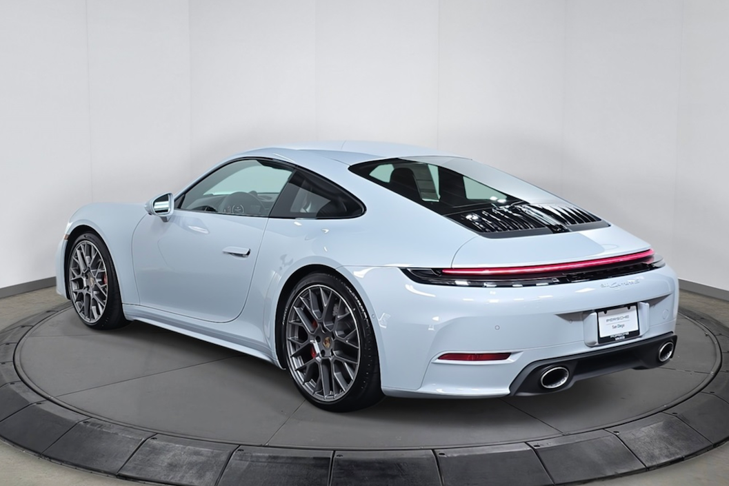White sports car on a turntable with a gray background