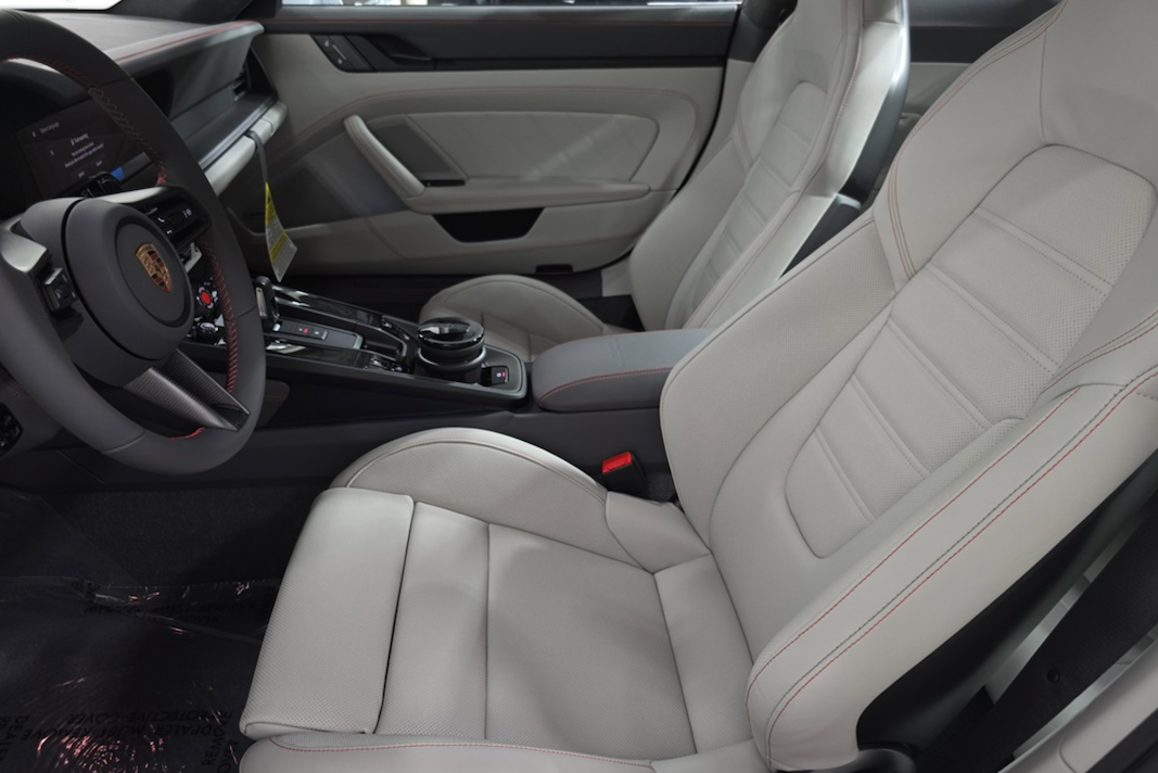 Car interior with beige leather seats and dashboard.
