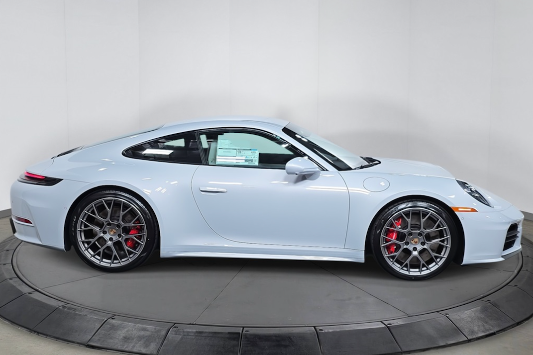 White Porsche car on a turntable with a gray background