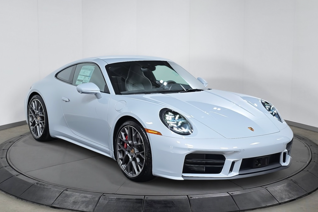 White Porsche car on a turntable with a plain background