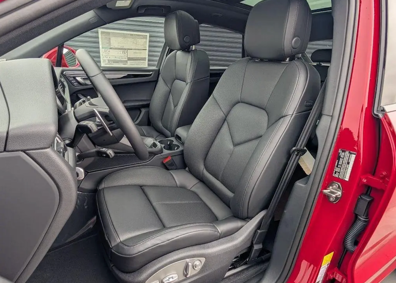 Gray car interior with a focus on the driver's seat and dashboard.