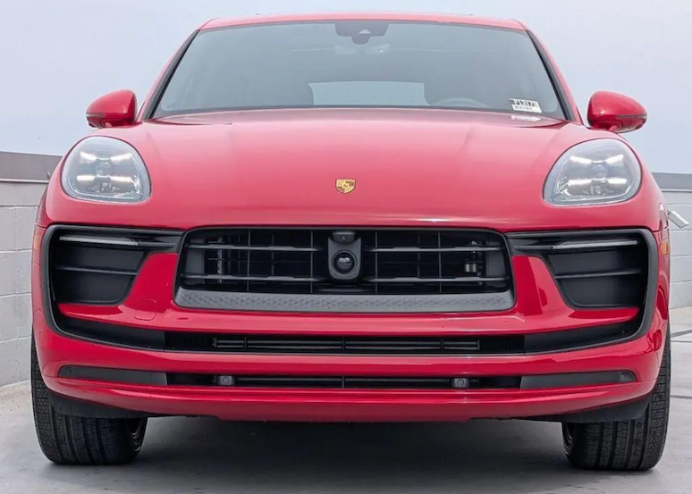 Red Porsche SUV front view on a gray background