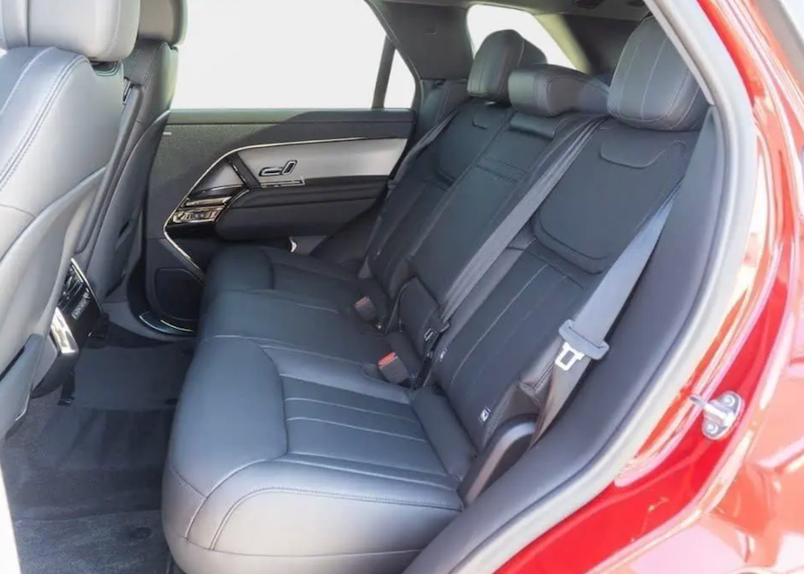 Gray car interior with visible seat belts and door panel.
