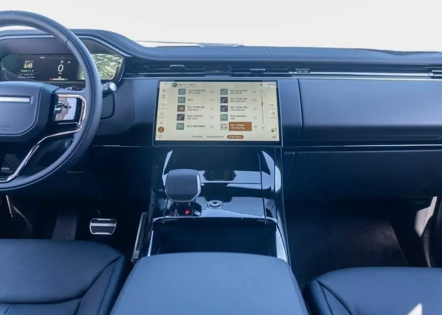 Car interior with a focus on the dashboard and steering wheel.
