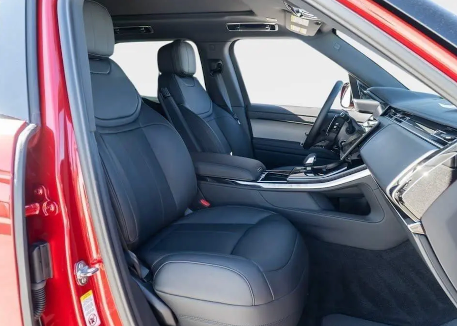 Car interior with gray seats and red door panel