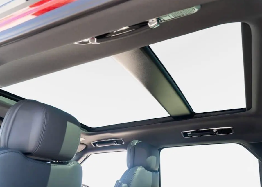 Car interior with a sunroof and headrests visible