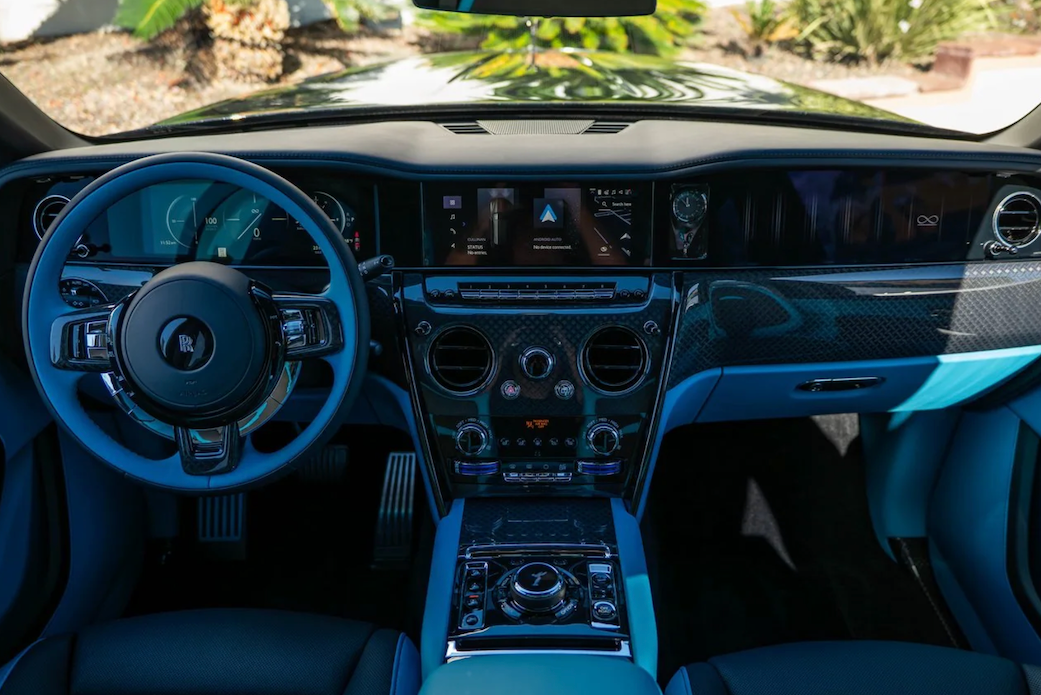 Luxury car interior with blue accents and modern dashboard.