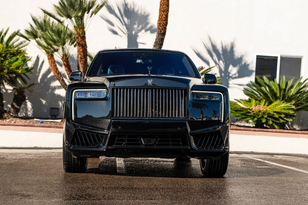 Black luxury SUV with palm trees in the background