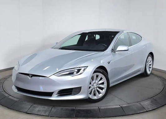 White Tesla car on a turntable against a white background