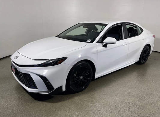 White Toyota car parked indoors with a plain background