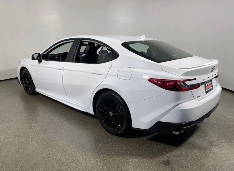 White car on a gray floor with a white wall background