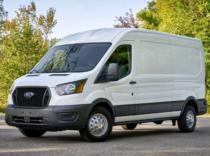 White Ford van on a road with trees in the background