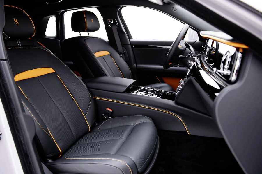 Luxury car interior with black leather seats and gold accents