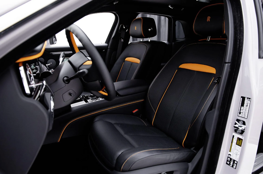Luxury car interior with black and orange accents