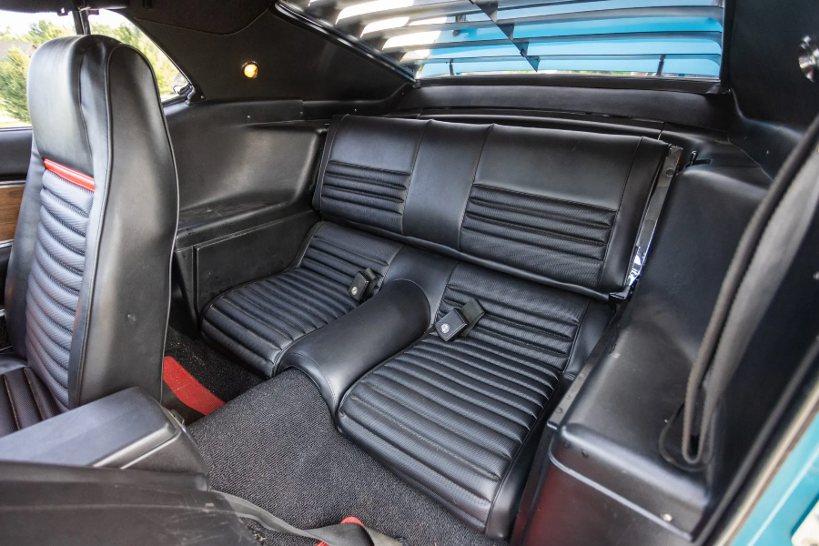 Black leather interior of a classic car with visible stitching