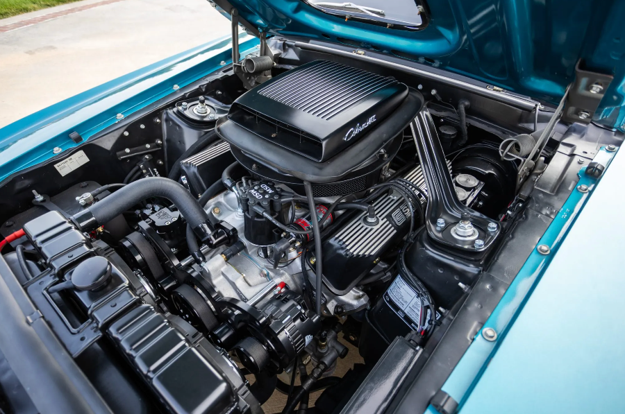 Car engine with 'Chevrolet' branding open in a vehicle.
