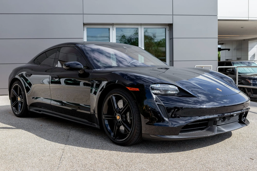 Black Porsche car parked in front of a building