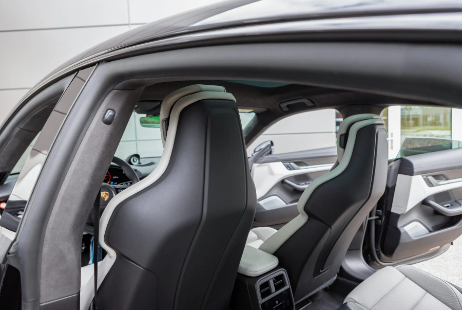 Close-up of a car interior with gray and white seats.