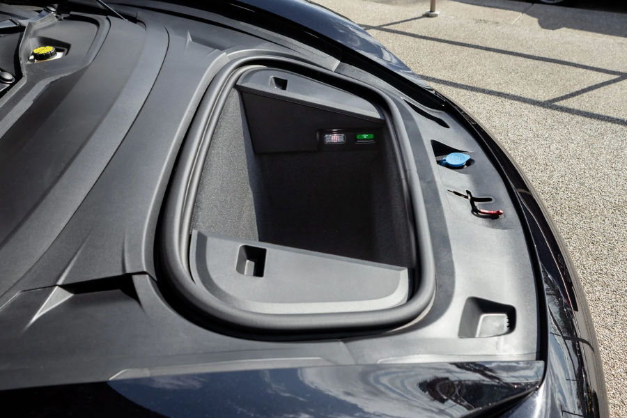 Close-up of a car's charging port cover on a vehicle