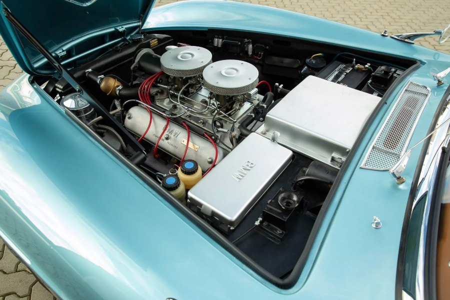 Engine compartment of a vintage car with visible components.