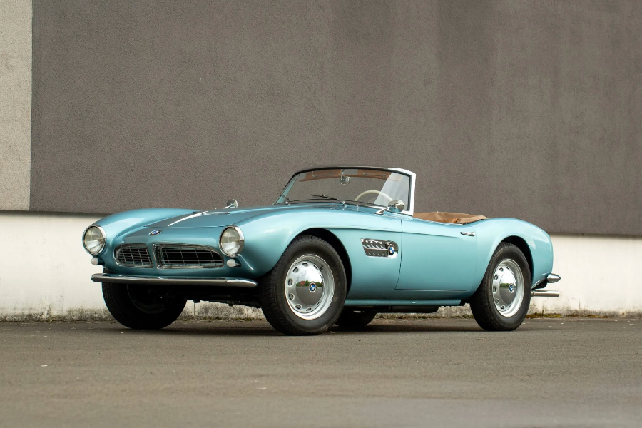 Vintage blue convertible car on a gray background