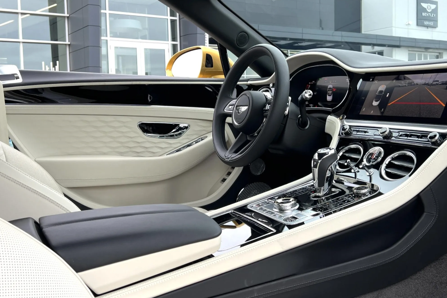 Luxury car interior with steering wheel and dashboard in a showroom setting