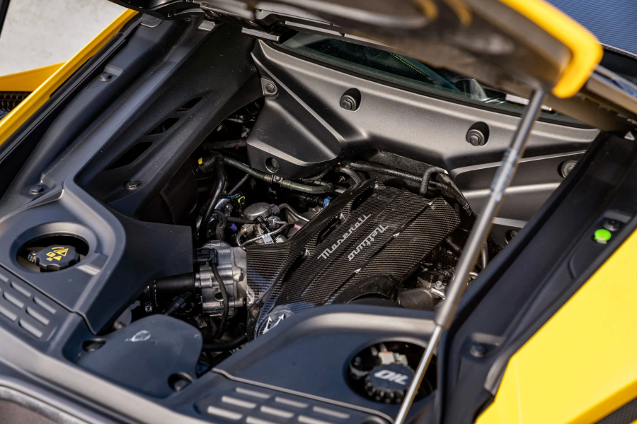 Car engine with Maserati branding open hood