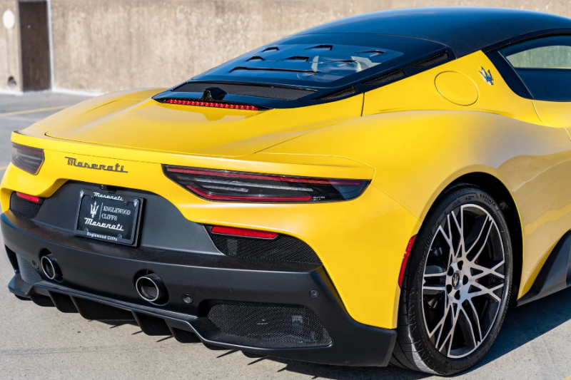 Yellow Maserati car parked on a concrete surface