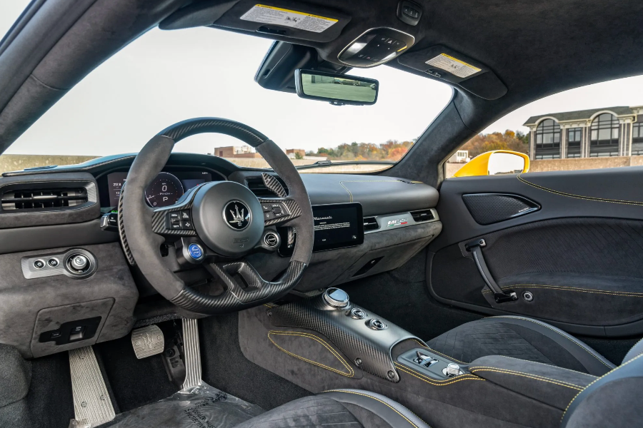 Car interior with steering wheel and dashboard in a vehicle.