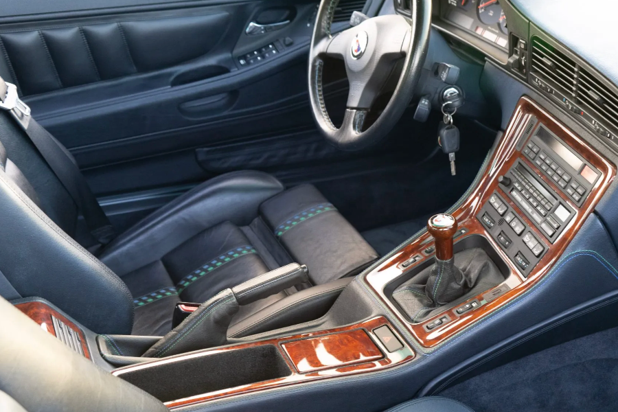 Car interior with steering wheel, dashboard, and center console.