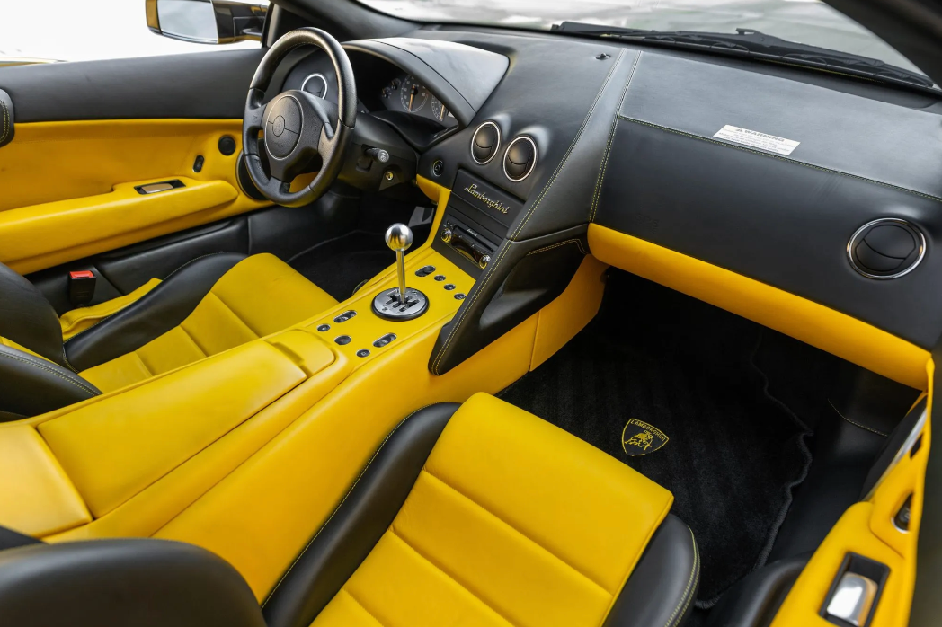Luxury car interior with yellow seats and black dashboard