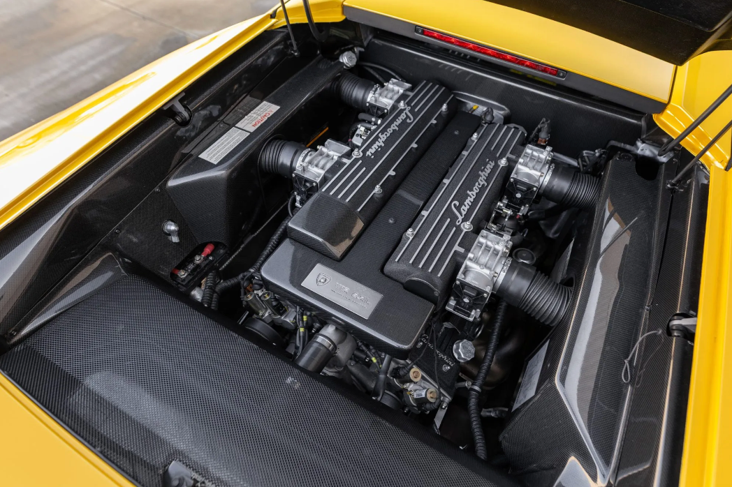 Engine of a yellow sports car with visible branding