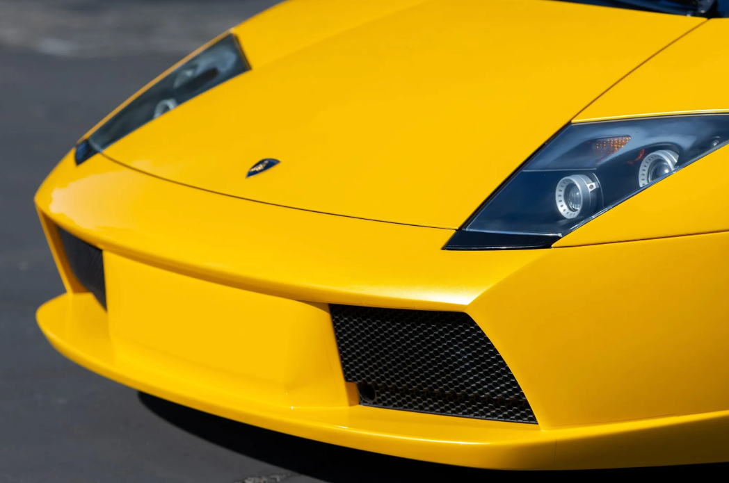 Close-up of a yellow Lamborghini car on a blurred background