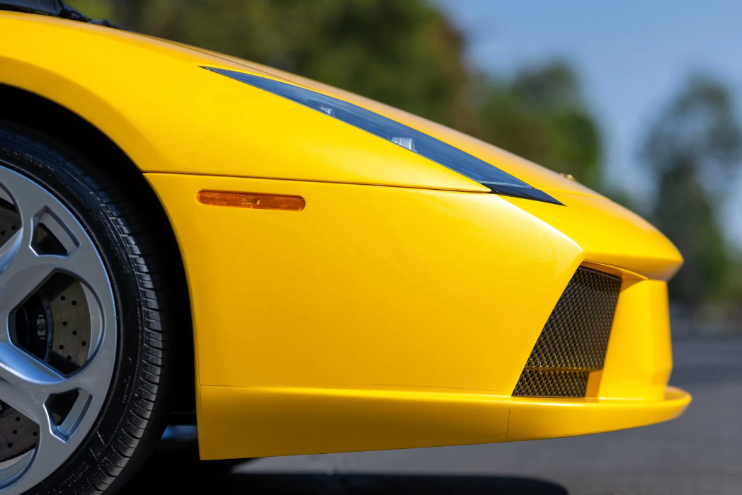 Yellow sports car with blue stripe on a blurred background