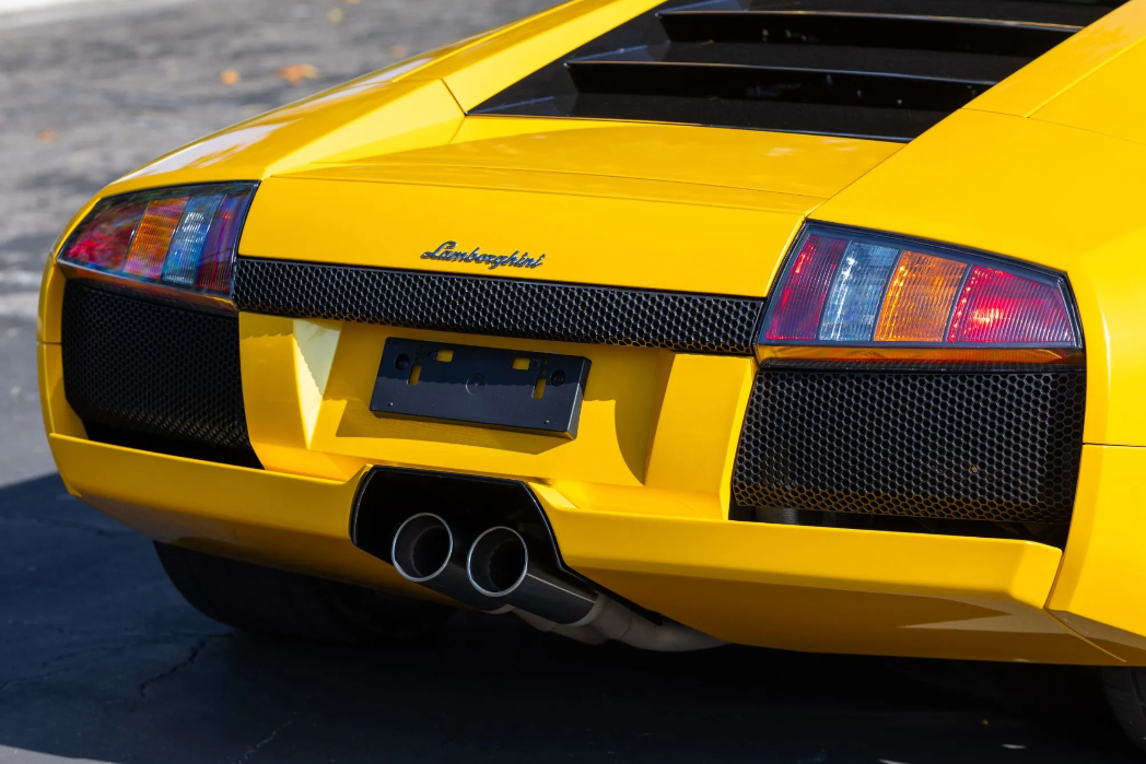 Yellow Lamborghini sports car with visible branding on a blurred background