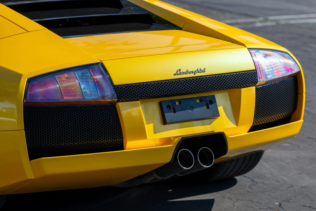 Close-up of a yellow Lamborghini car on a road