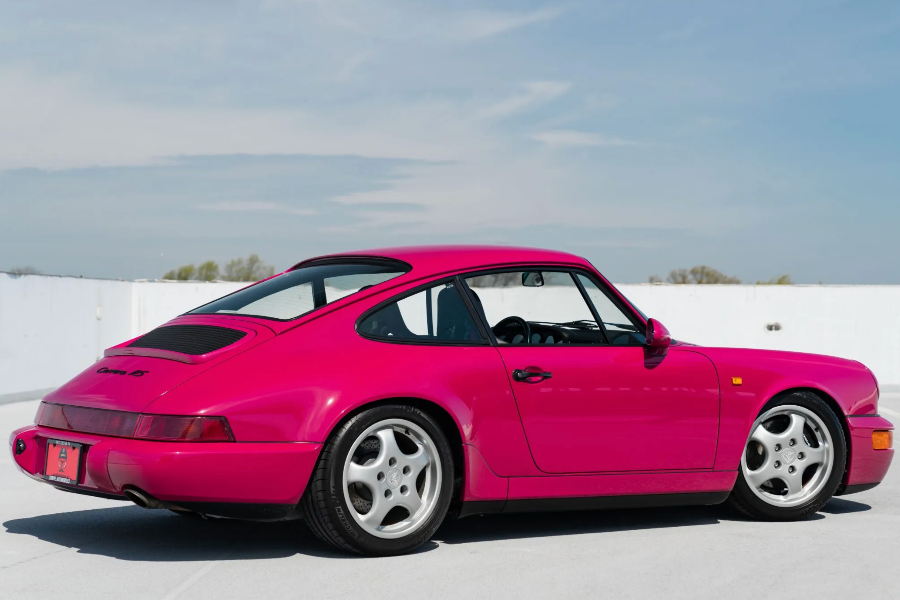 Pink sports car on a white background